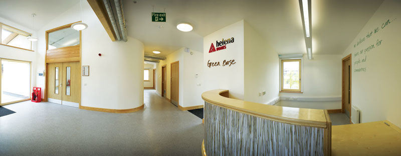 The reception area with desk featuring recycled materials and expressed ventilation ductwork