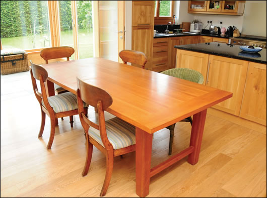 the kitchen table, with the hand-made kitchen by Eamon O’Sullivan and sun space in the backgroun