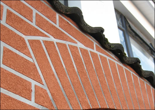 A terrace in North Dublin (below) where three householders externally insulated with a brick-like render finish (above) to base and a napp finish render