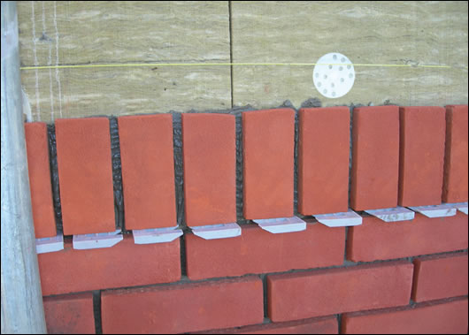 (below and above) Ibstock’s Brickshield system, with Rockwool high density external insulation coated in the company’s adhesive mortar, before Ibstock brick slips are applied