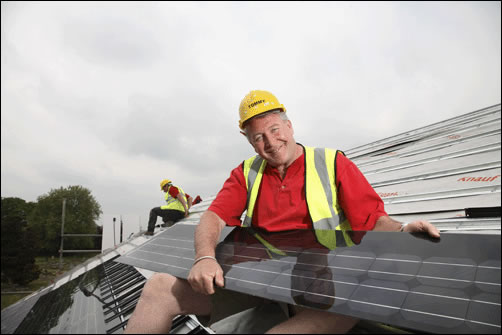 Tommy Walsh holding Nu-lock solar PV panels going into this 'ecohouse' project